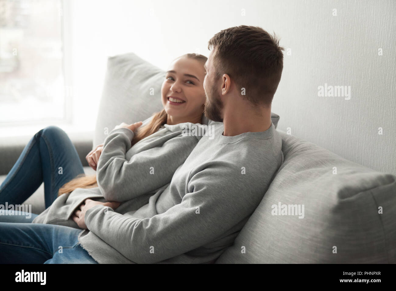 Loving millennial couple hugging relaxing on cozy couch Stock Photo Alamy