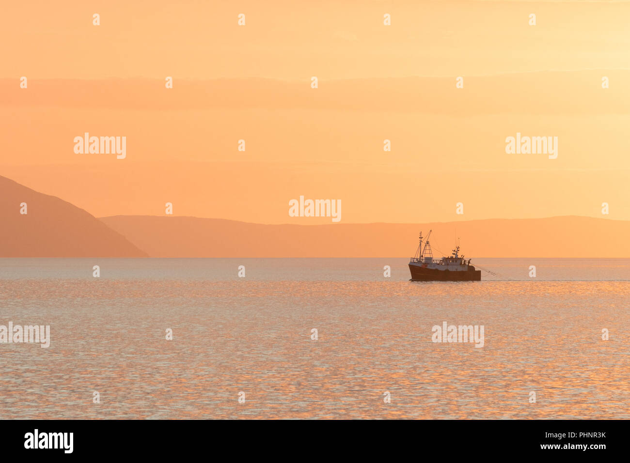 Fishing boat sunset - Firth of Clyde, Scotland, UK Stock Photo