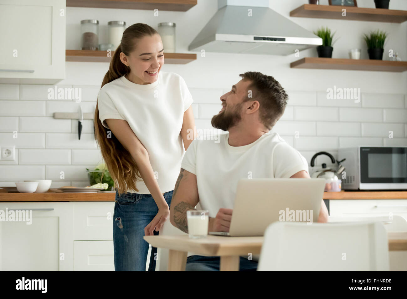 Smiling couple looking at each other before having breakfast tog Stock Photo