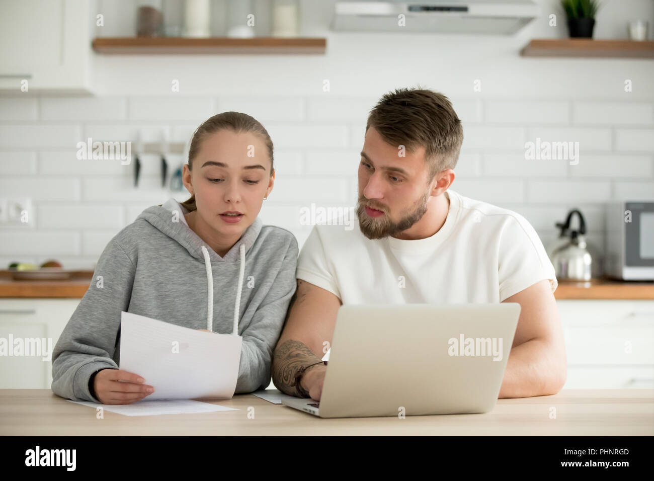Serious couple analyzing budget or utility bills at home Stock Photo