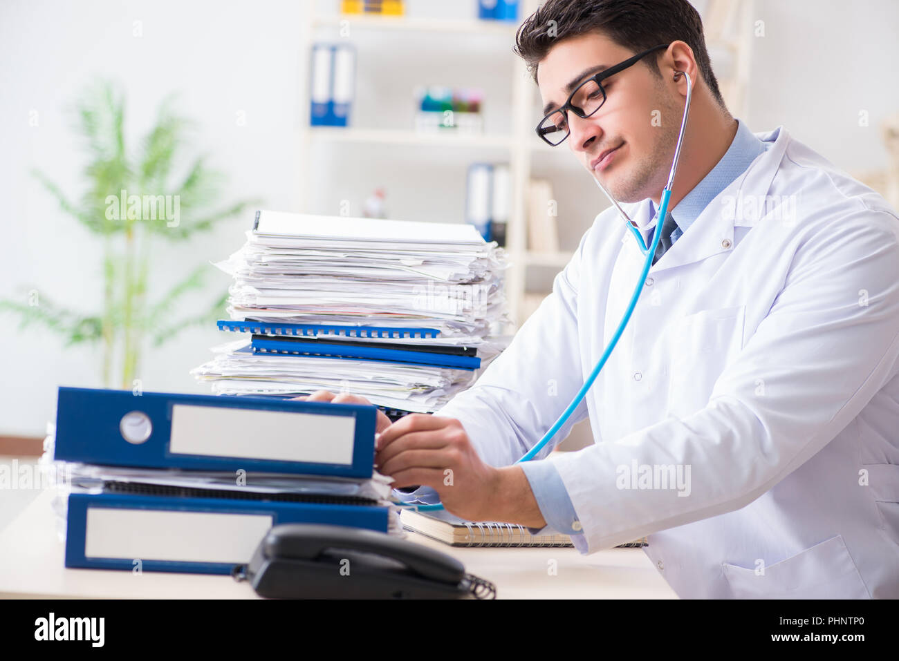 Busy doctor with too much work in hospital Stock Photo Alamy
