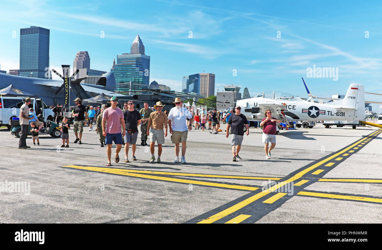 Cleveland, Ohio, USA, 1st Sept, 2018.  Spectators walk around Burke Lakefront Airport in downtown Cleveland Ohio during the 54th Annual Labor Day Weekend National Air Show.  The downtown Cleveland skyline can be seen in teh background while on the grounds of the show are aircraft that can be viewed and toured.  Credit: Mark Kanning/Alamy Live News. Stock Photo