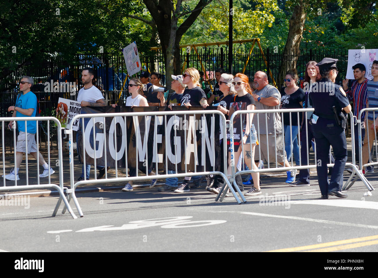 New York, NY, USA. 1st September, 2018. Animal rights activists march behind police barricades during the Official Animal Rights March NYC. Stock Photo