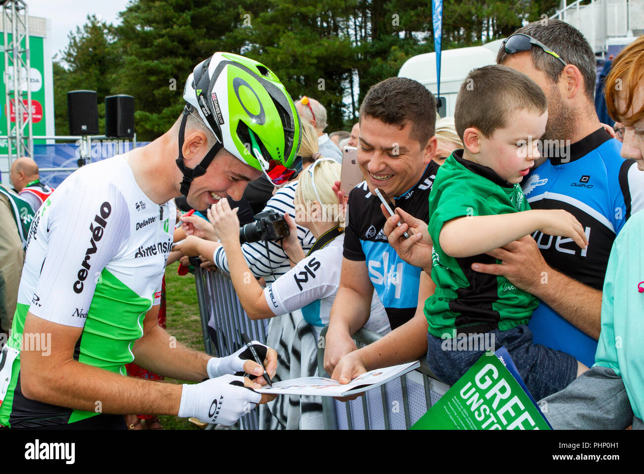 Professional cyclist Scott Davies (Wales) of Carmarthen (TEAM DIMENSION DATA) signs autographs ahead of the start of Stage 1 of the Tour of Britain cycling race starting at Pembrey Country Park. Stock Photo
