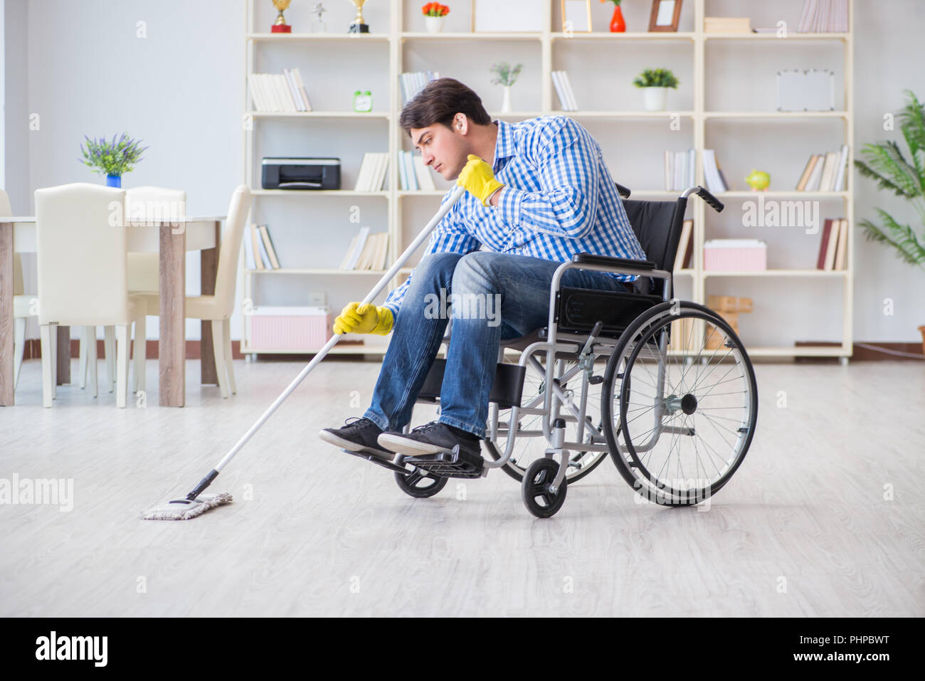 Disabled man on wheelchair cleaning home Stock Photo Alamy