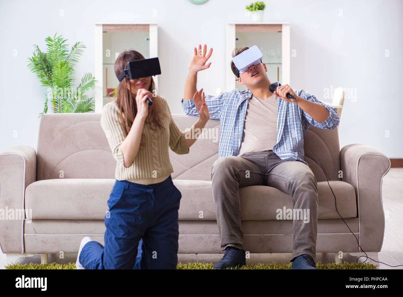 Pair singing karaoke with virtual reality glasses Stock Photo Alamy