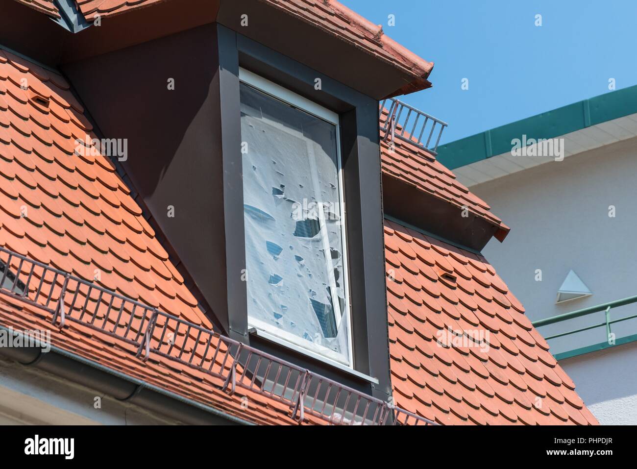 Broken fly screen on a roof window Stock Photo