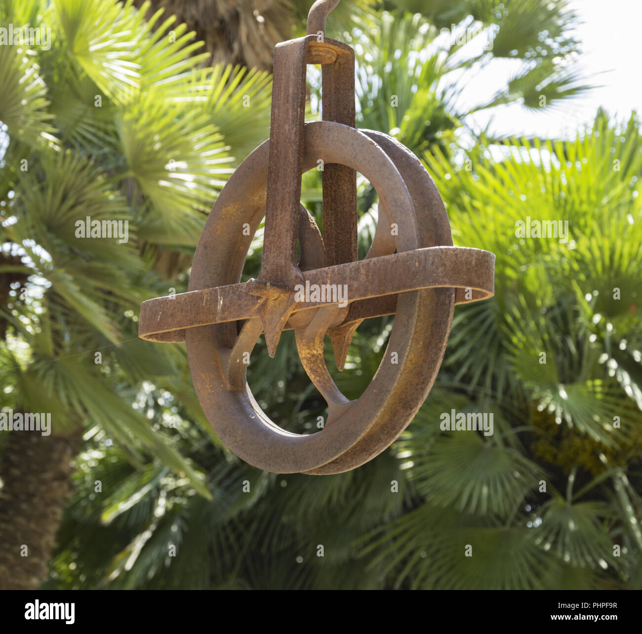 Old disused pulley formerly used to extract water from a well. Stock Photo
