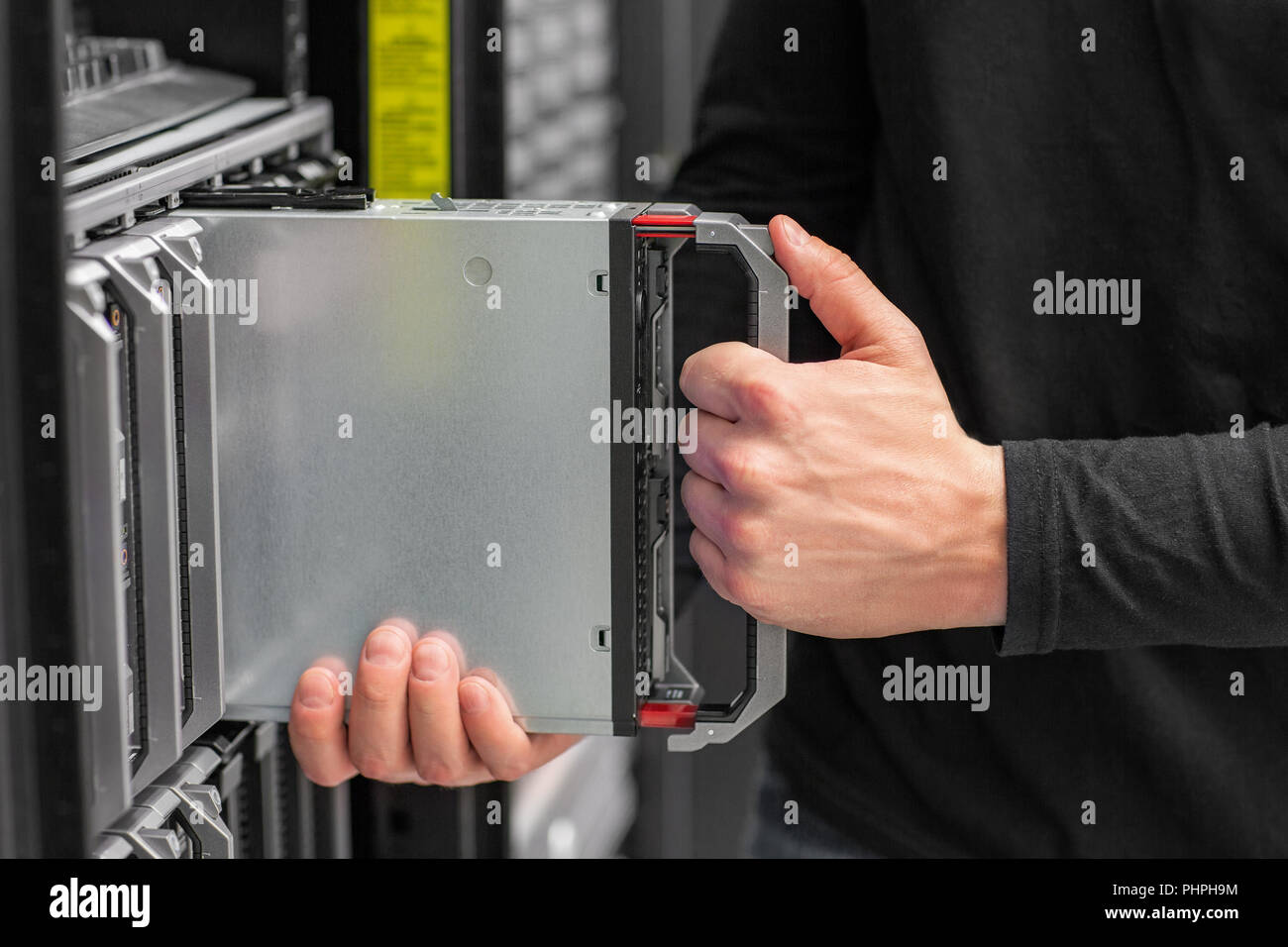Close-up of IT consultant install blade Server in datacenter Stock Photo