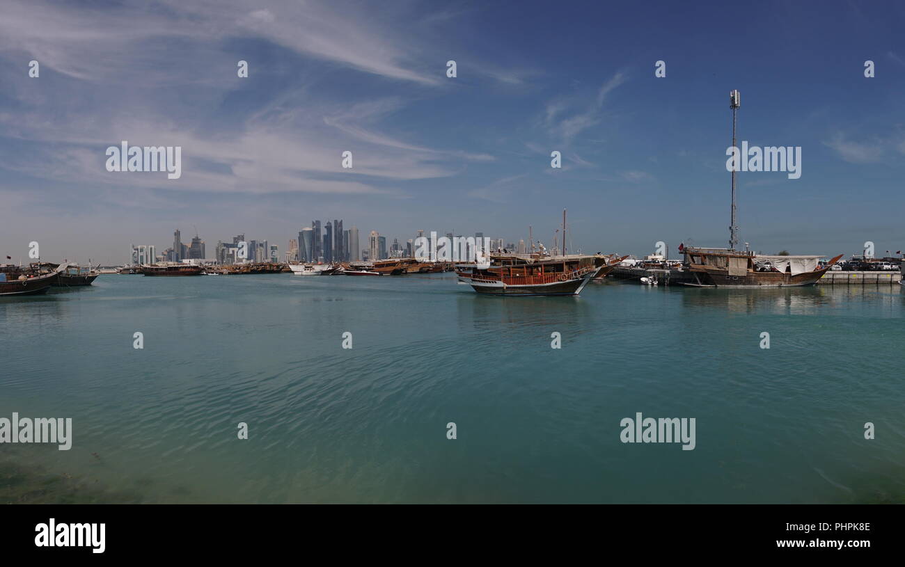 Beautiful Doha Skyline View with Traditional Wooden Boats. Corniche Broadway. Qatar, Middle East Stock Photo