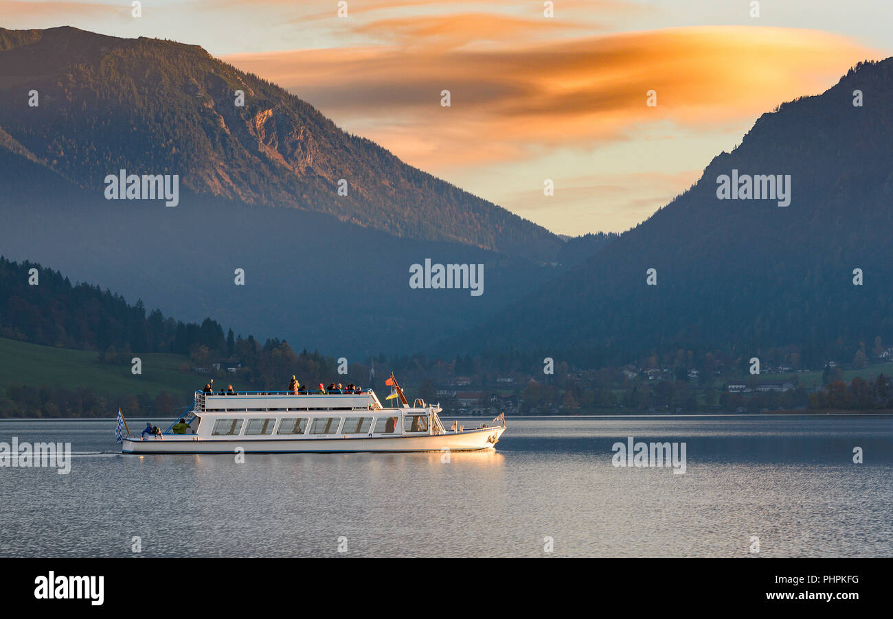 Pleasure boat on Alpine lake in Bavaria in the evening time before sunset Stock Photo