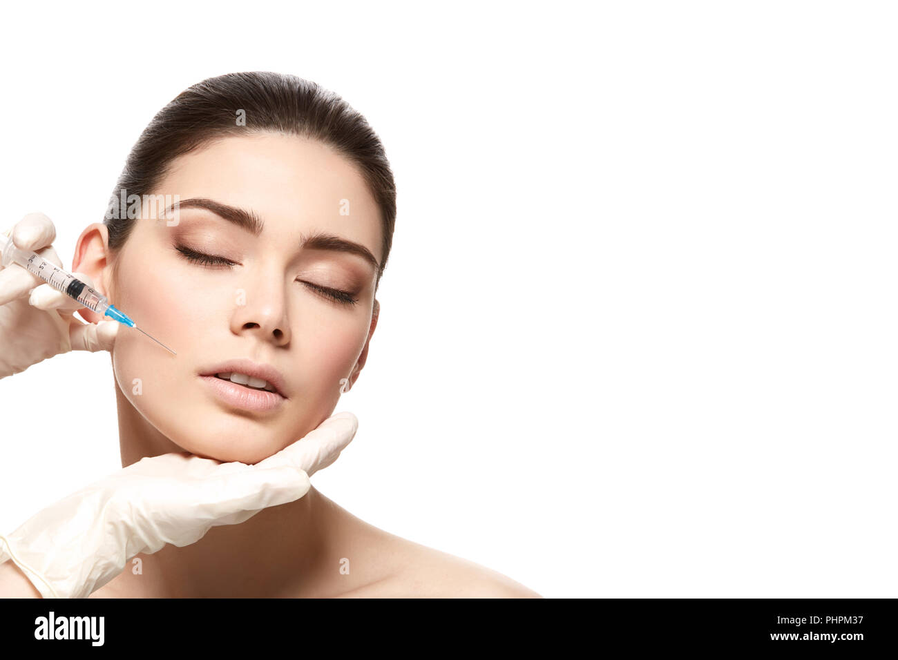 beautiful young woman with natural makeup getting face collagen ...