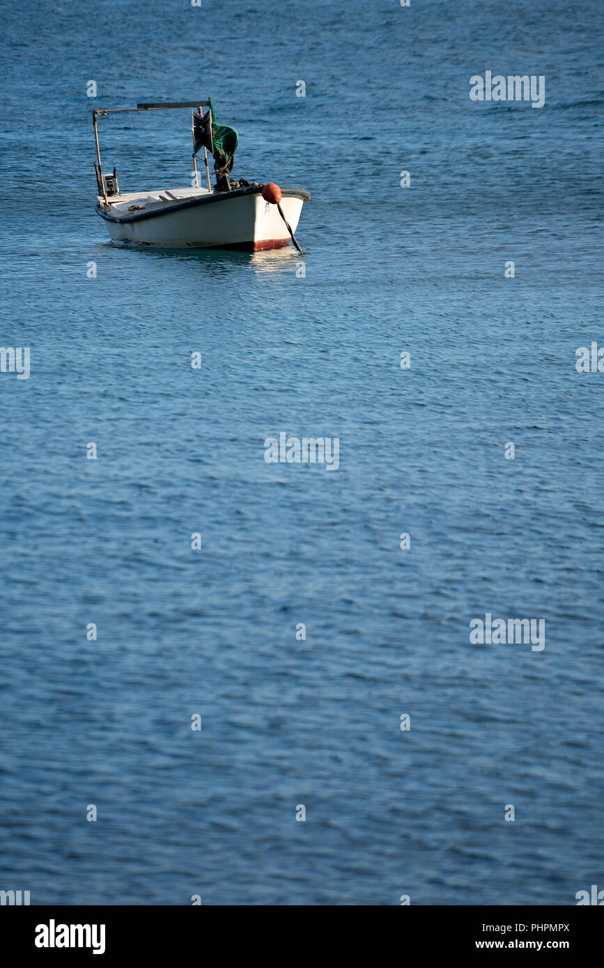 Small empty fisherman boat on a lake Stock Photo