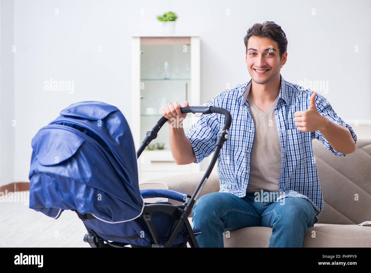 Young father looking after newborn baby at home Stock Photo