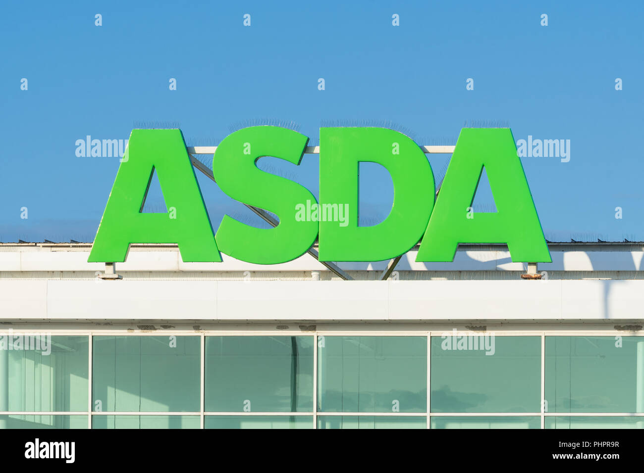 Asda supermarket sign, UK - against blue sky Stock Photo