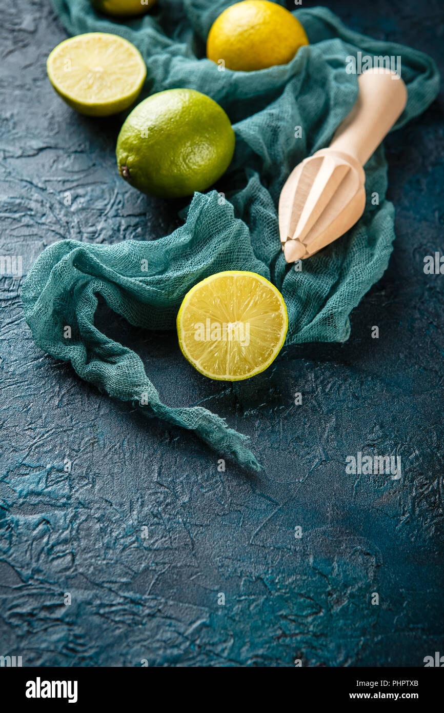 Fresh limes with citrus juicer stick Stock Photo Alamy