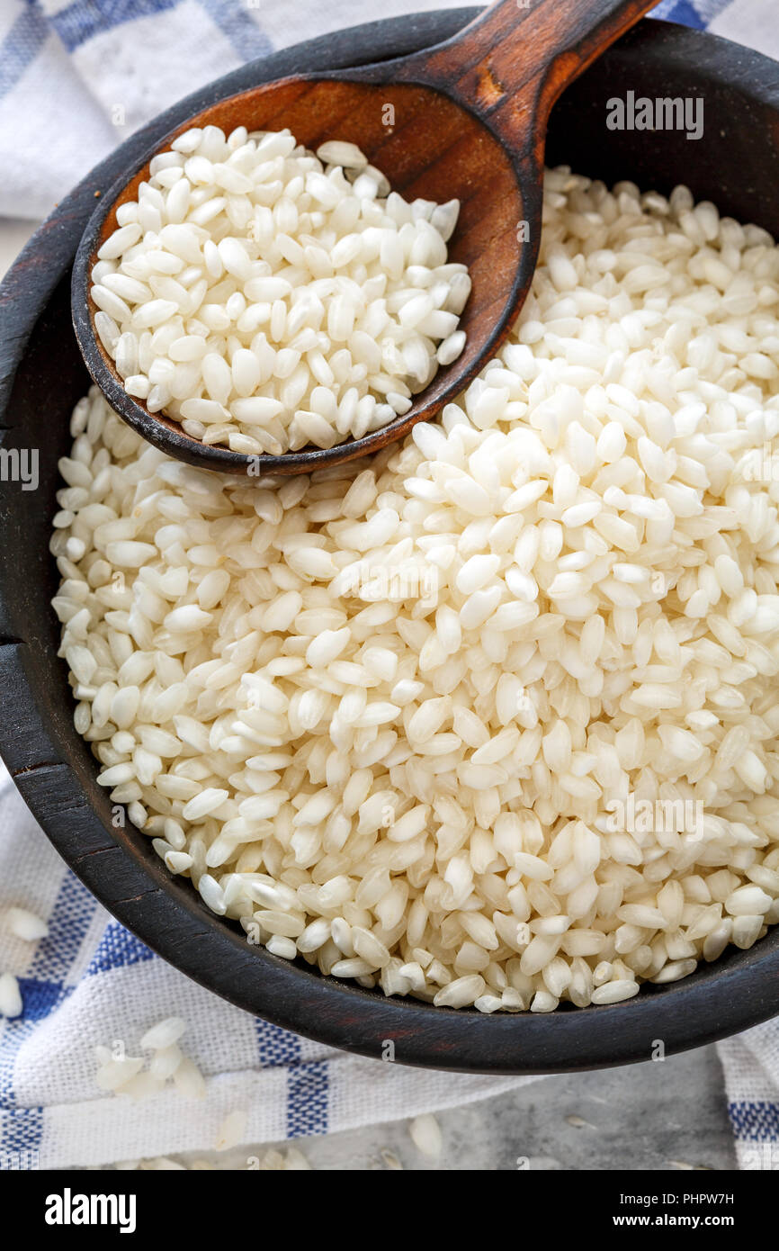 White round rice in a wooden bowl. Stock Photo