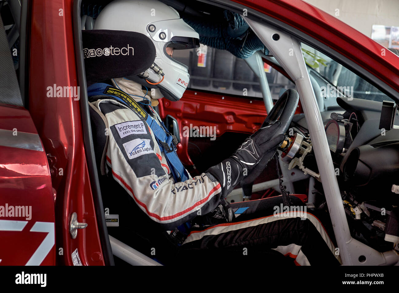 Racing car driver. Interior view of a driver behind the wheel of a race prepared saloon car Stock Photo