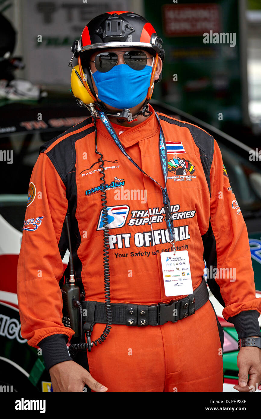 Pit crew. Pit safety official at a motorsport race track in full safety equipment and clothing. Bira race circuit Pattaya Thailand Southeast Asia Stock Photo