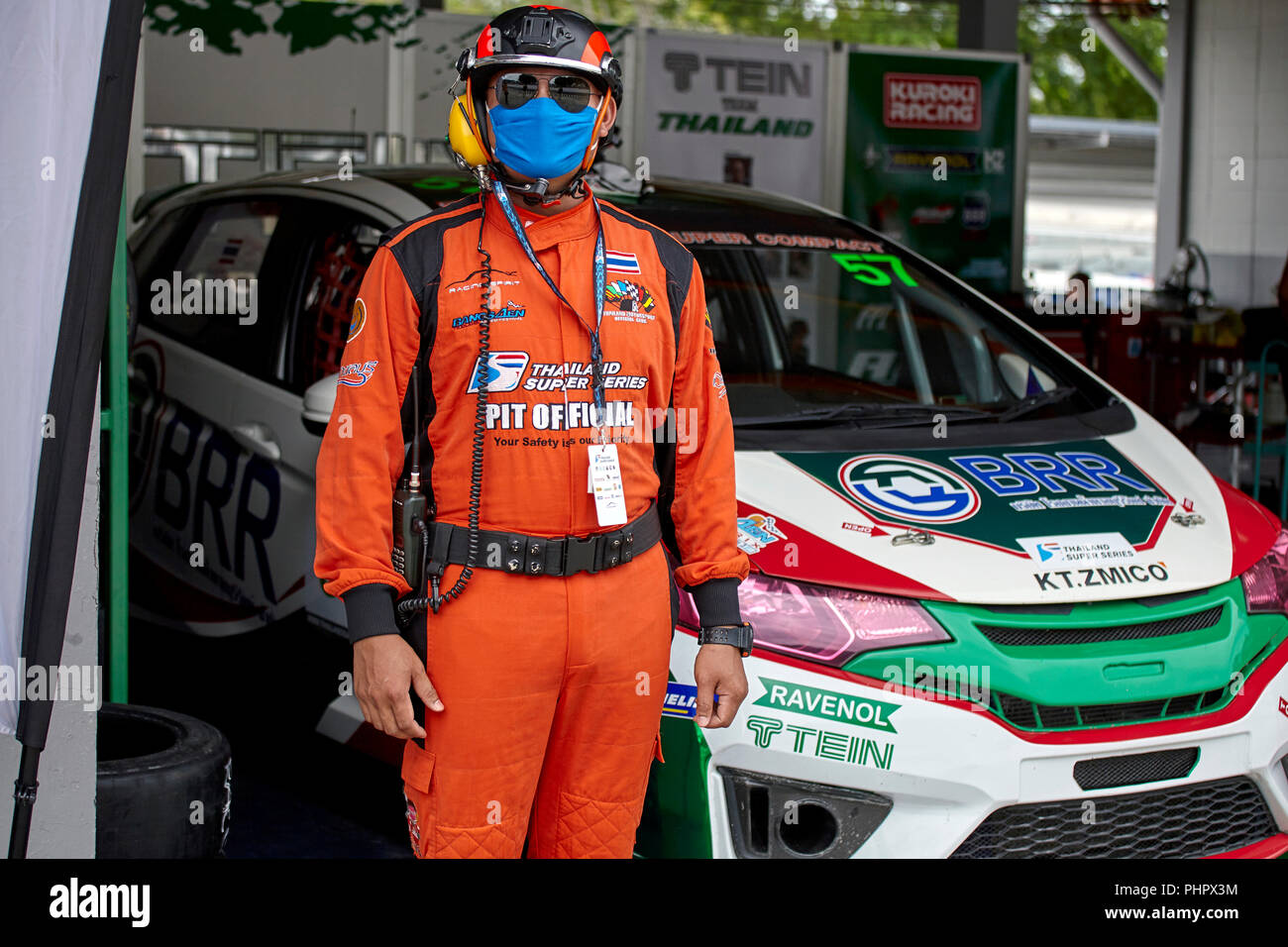 Pit crew. Pit safety official at a motorsport race track in full safety equipment and clothing