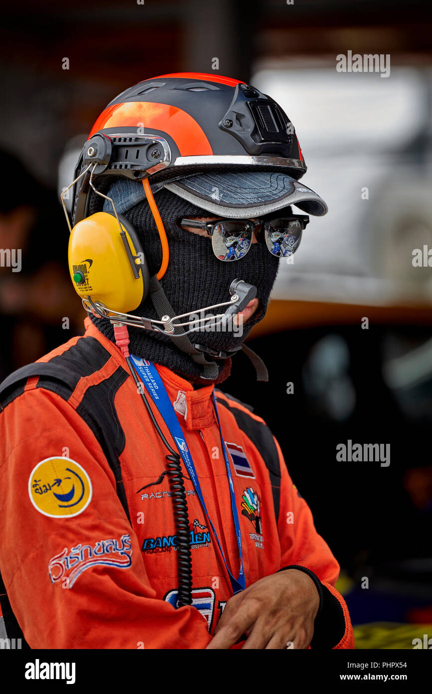 Pit crew. Pit safety official at a motorsport race track in full safety equipment and clothing. Bira race circuit Pattaya Thailand Southeast Asia Stock Photo