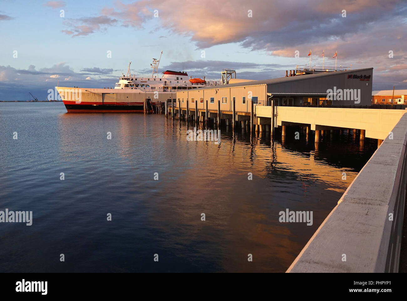 Evening sun on Terminal Black Ball Ferryline and MV Como in Port Angeles, Washington, USA Stock Photo