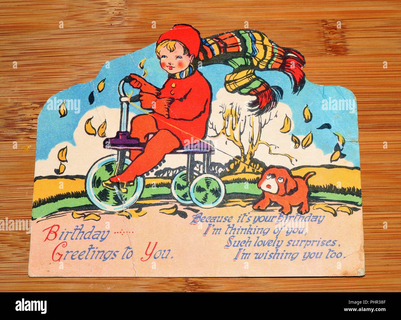 Vintage Greeting Card showing boy on bike - Social history Stock Photo