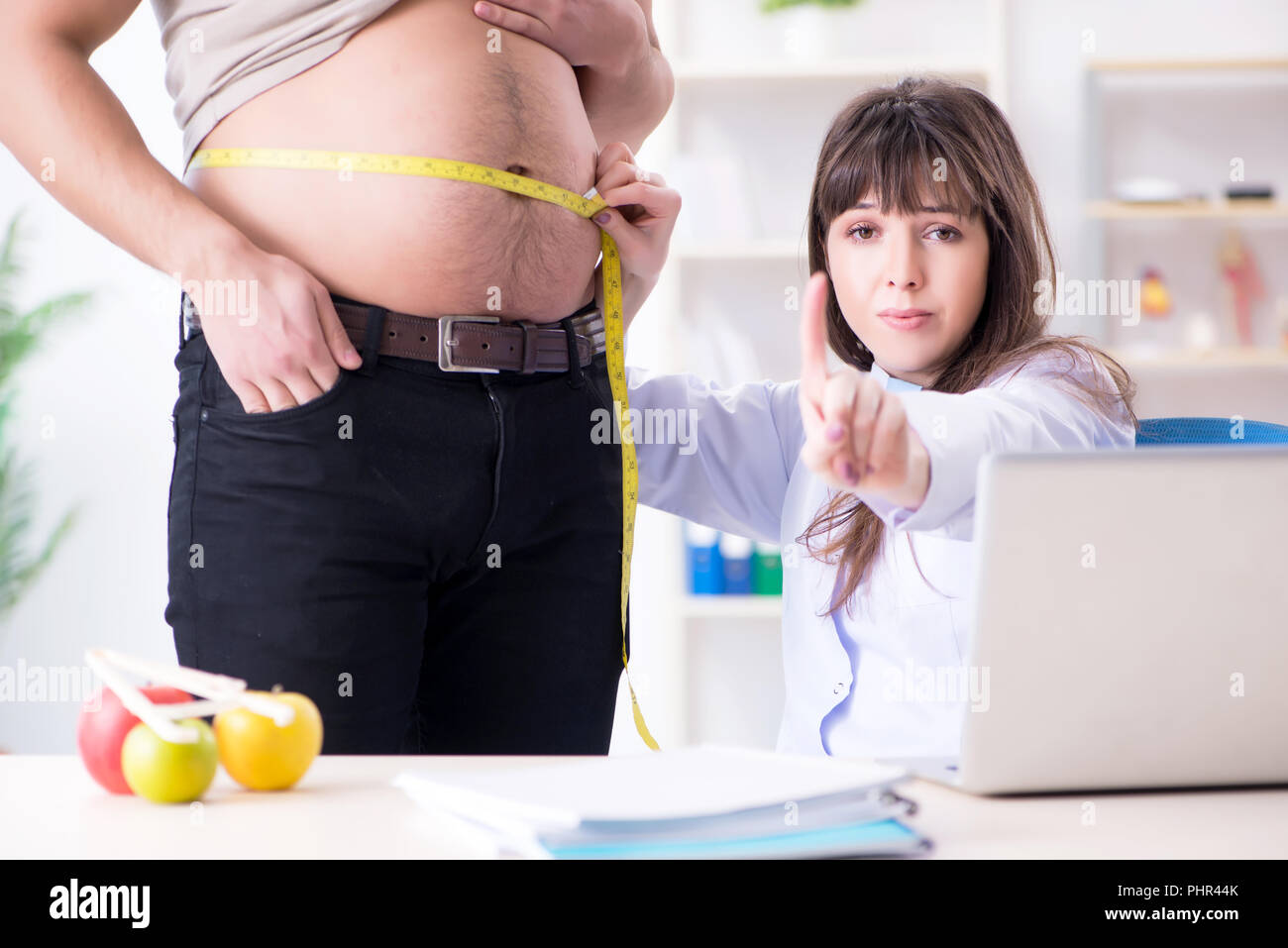 Doctor dietician giving advices to fat overweight patient Stock Photo