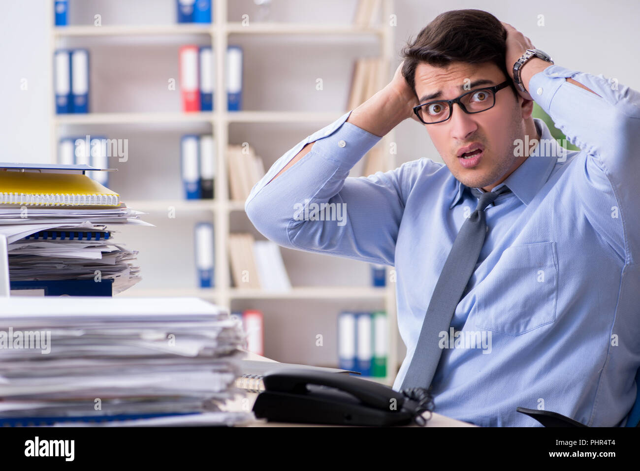 Extremely busy businessman working in office Stock Photo - Alamy