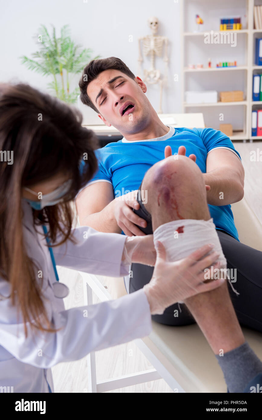 Patient visiting doctor after sustaining sports injury Stock Photo
