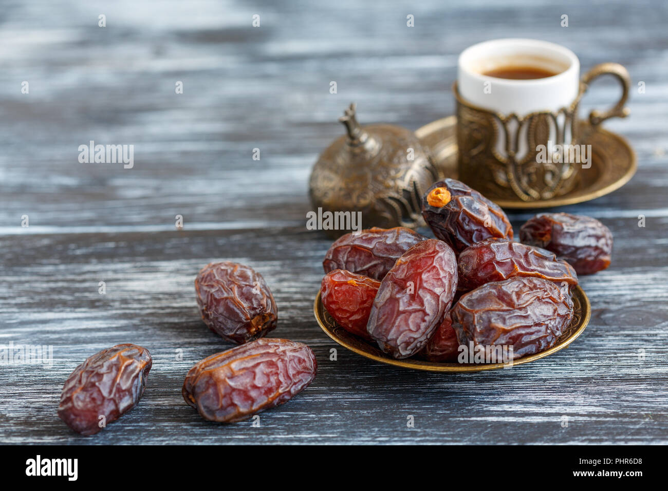 Dates on the plate and black coffee. Stock Photo