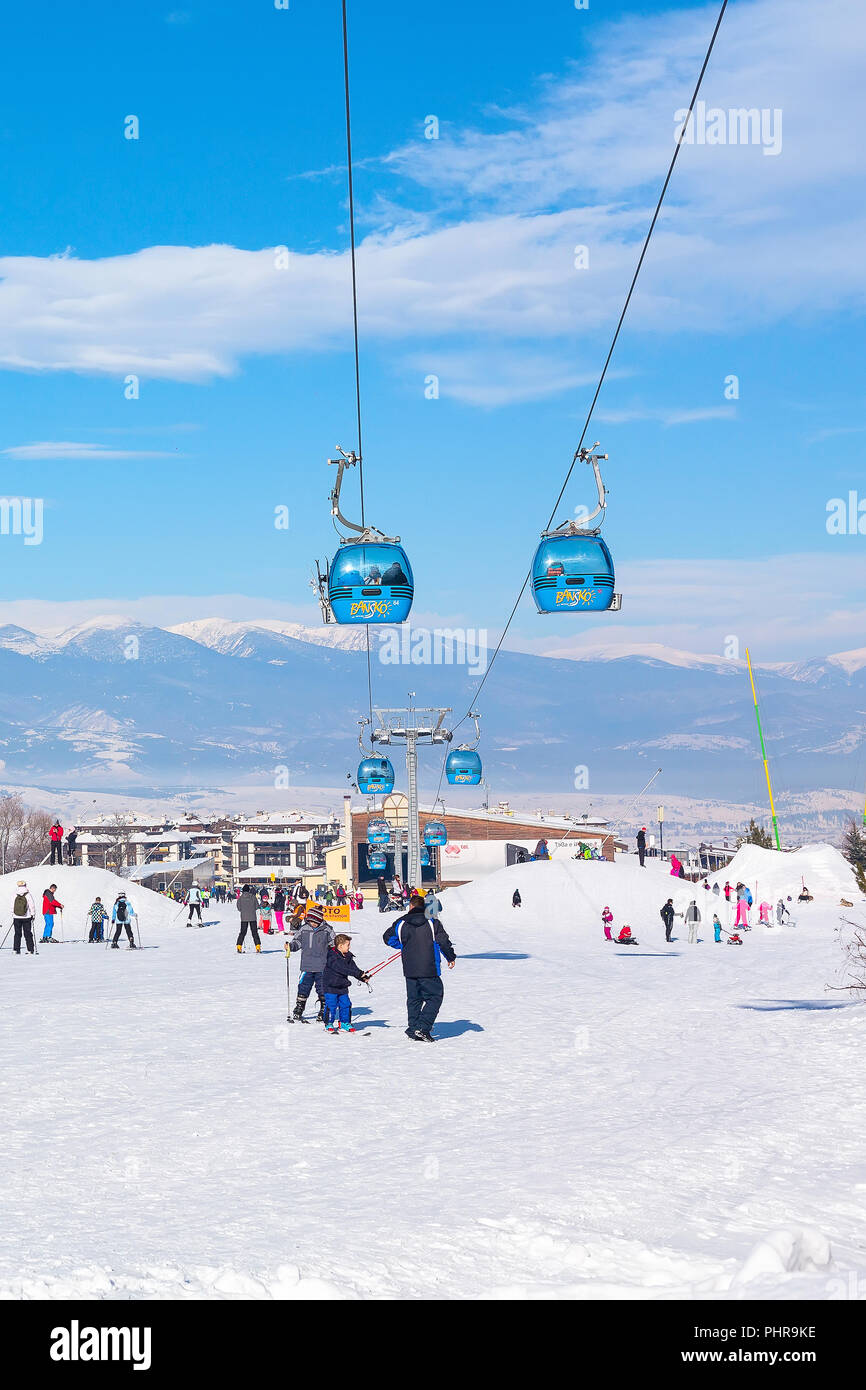 Bansko, Bulgaria - January 13, 2017: Winter ski resort Bansko, ski slope, people skiing and mountains view Stock Photo