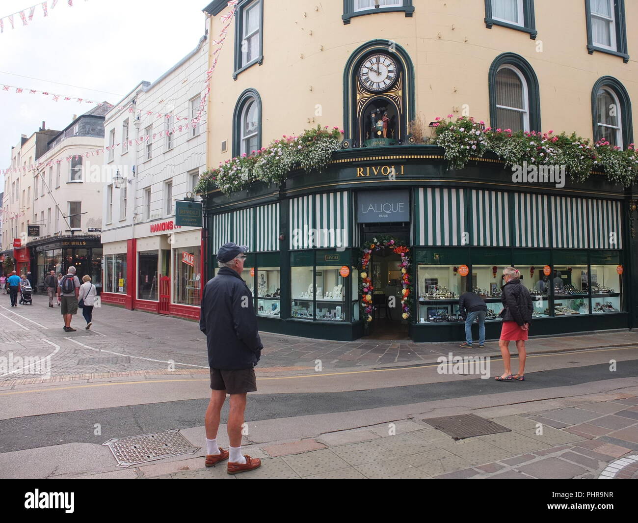Crowd gathering to watch mechanical clock on Rivoli Jewellers St Helier  which revolves on the hour to display animated scenes of Jersey life Stock  Photo - Alamy