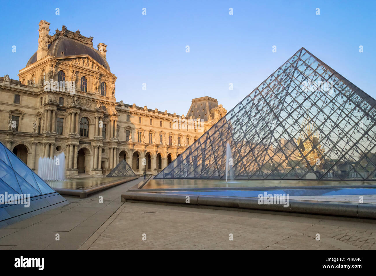 Paris, France - August 28, 2018: The Louvre Pyramid in Paris, France. It serves as the main entrance to the Musee du Louvre. Stock Photo