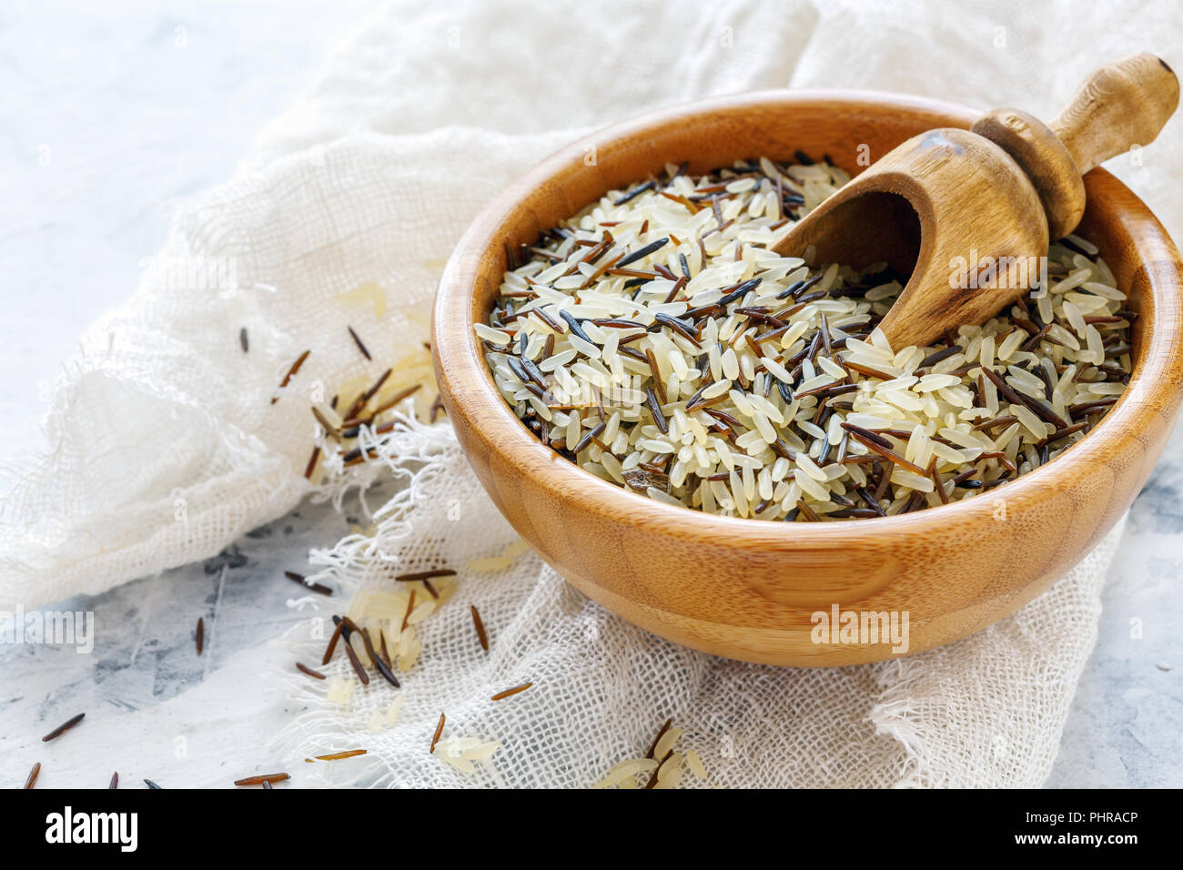 Mixture of white and wild rice in a wooden bowl. Stock Photo