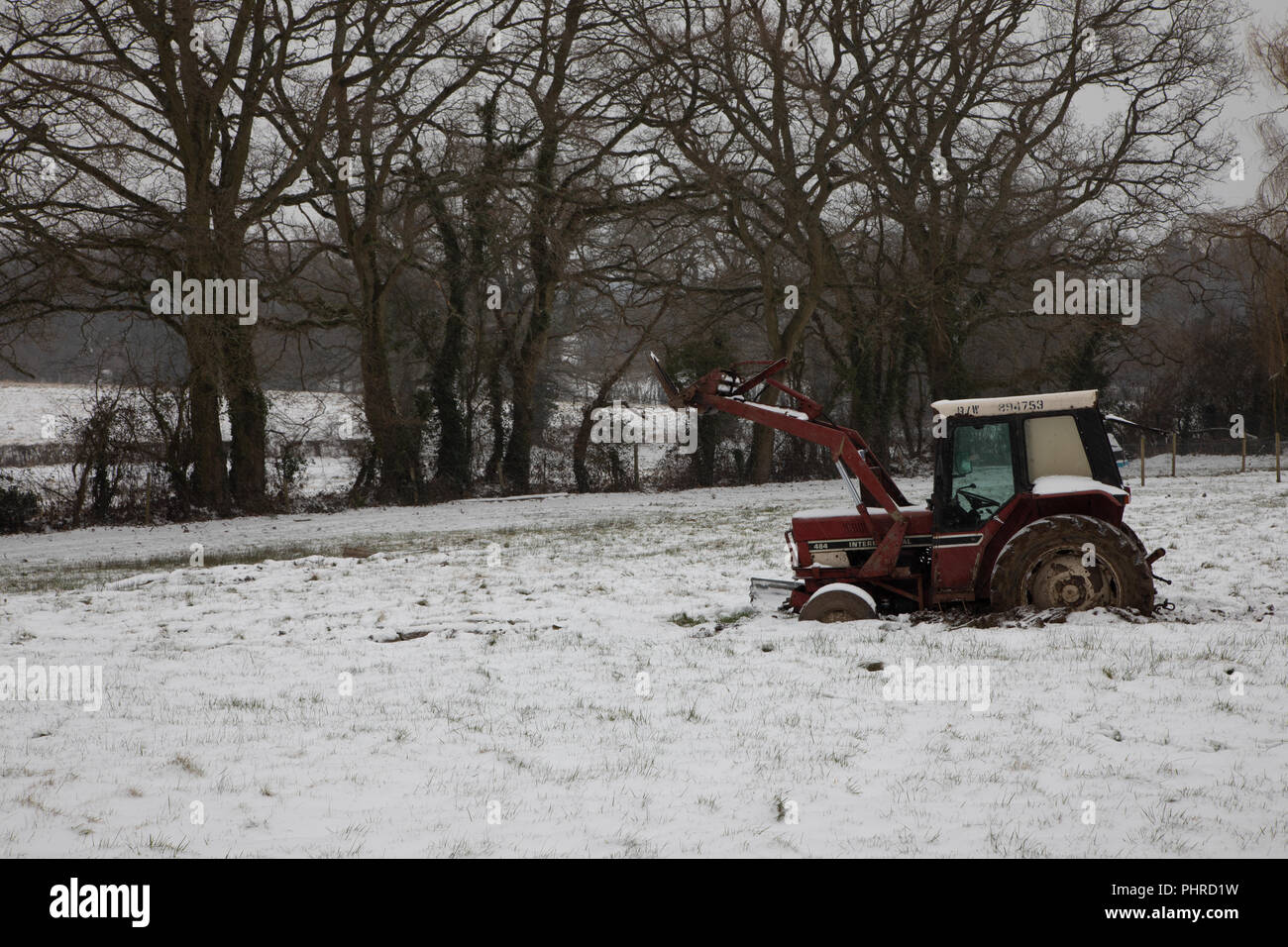 Tractor stuck in snowy field winter Stock Photo Alamy