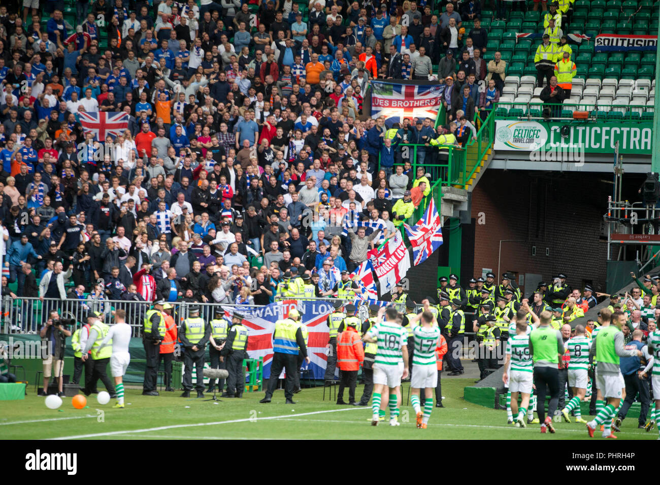 Rangers Fans Look On As Celtic Players Celebrate Victory After The Ladbrokes Scottish Premiership Match At Celtic Park Glasgow Stock Photo Alamy