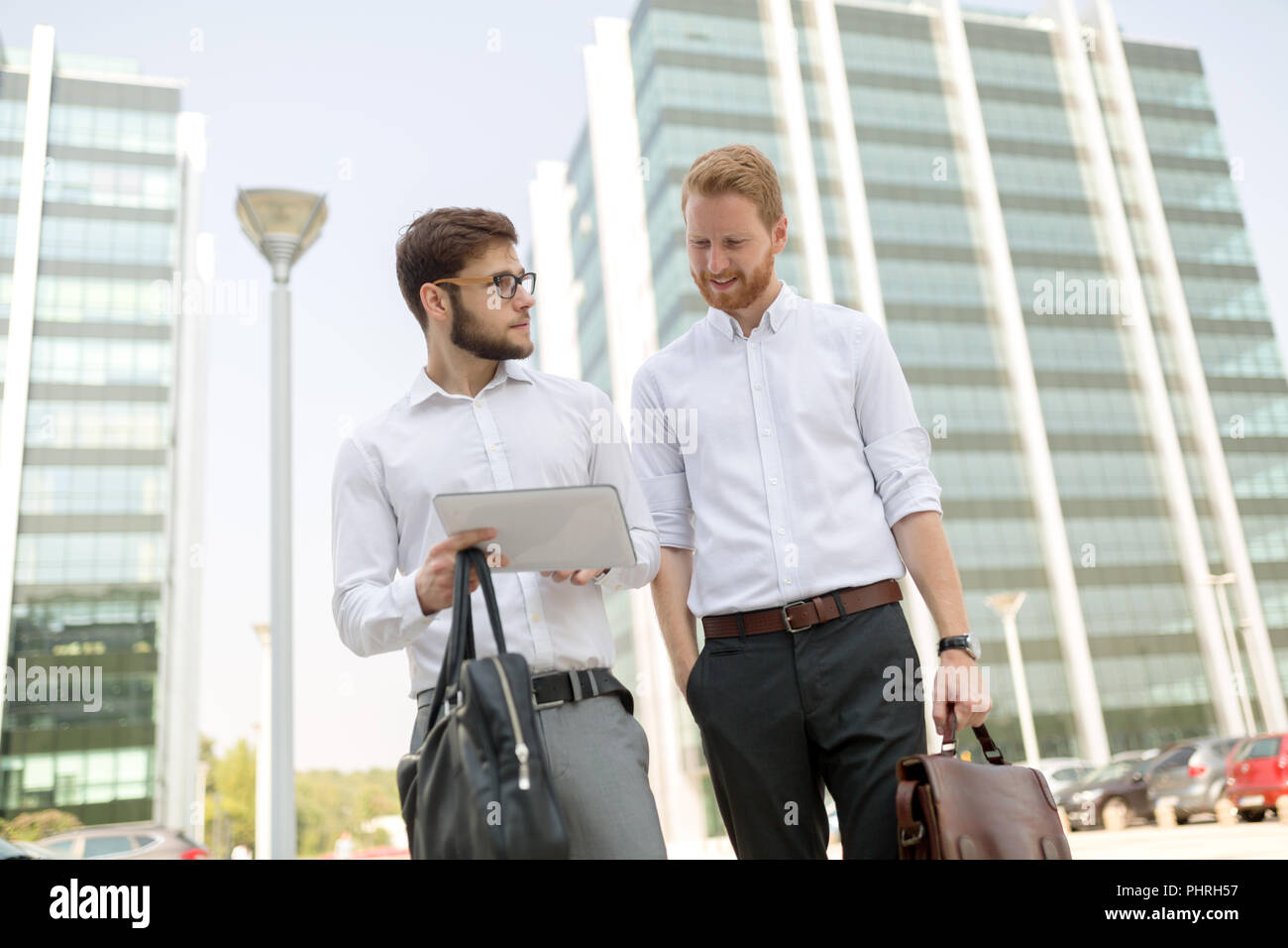 Business people talking outdoors Stock Photo - Alamy