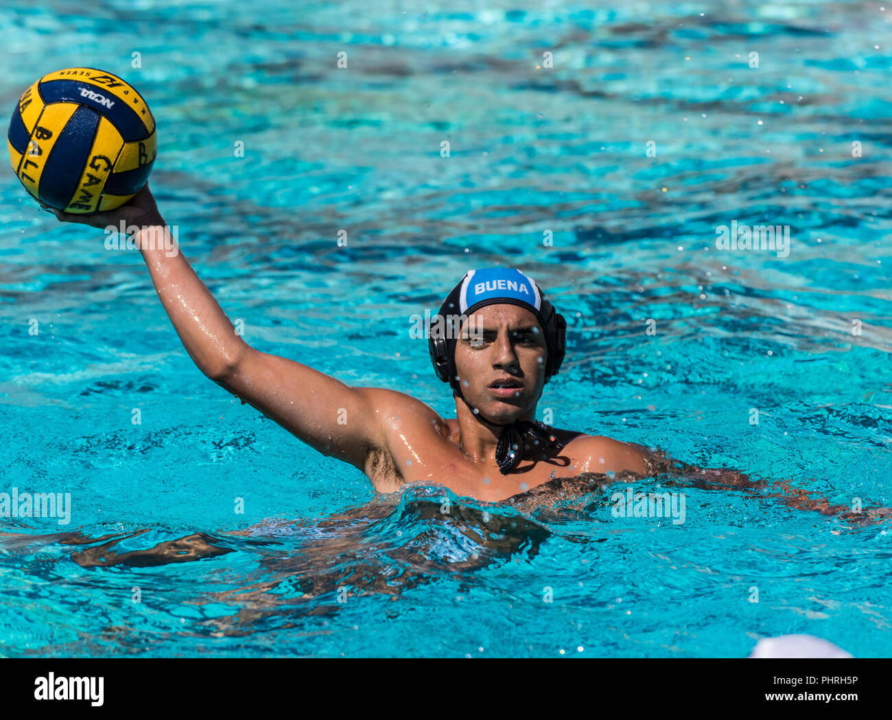 Buena High School's water polo player hold ball out while looking for a passing lane during game  in Ventura, California on August 28, 2018. Stock Photo