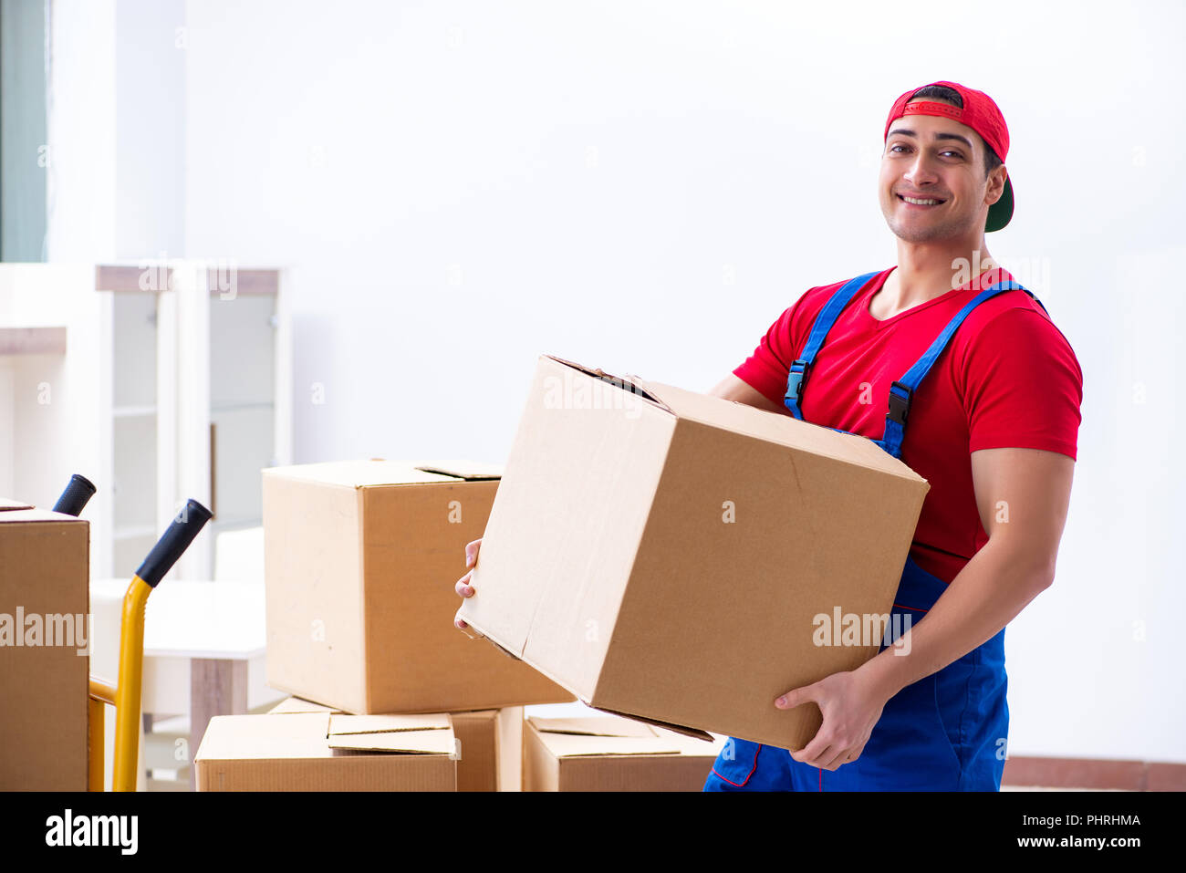 Contractor worker moving boxes during office move Stock Photo - Alamy