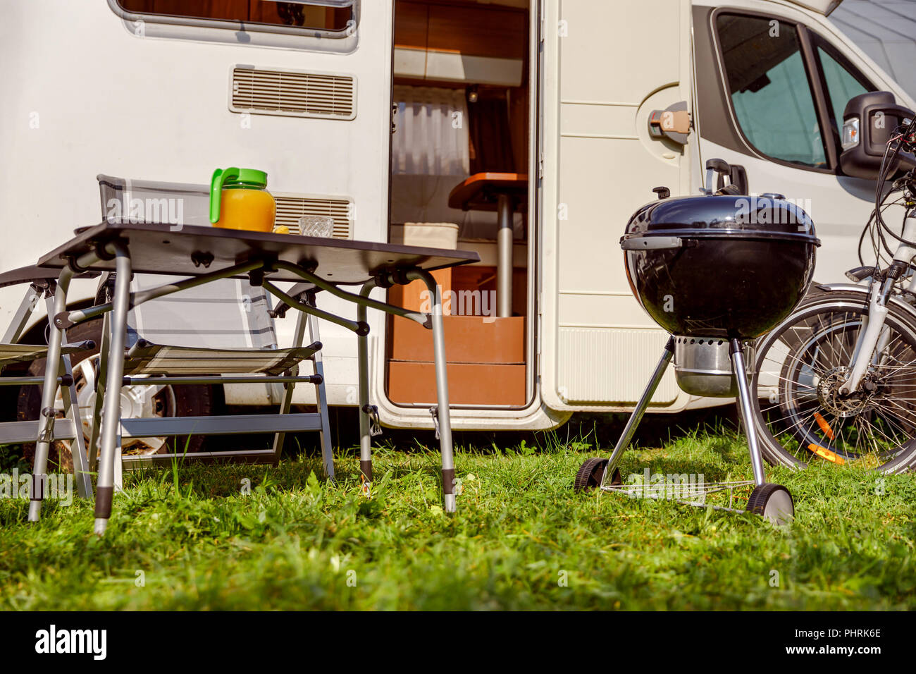 Family vacation travel RV, holiday trip in motorhome, Caravan car Vacation. Picnic with outdoor barbecue. Stock Photo