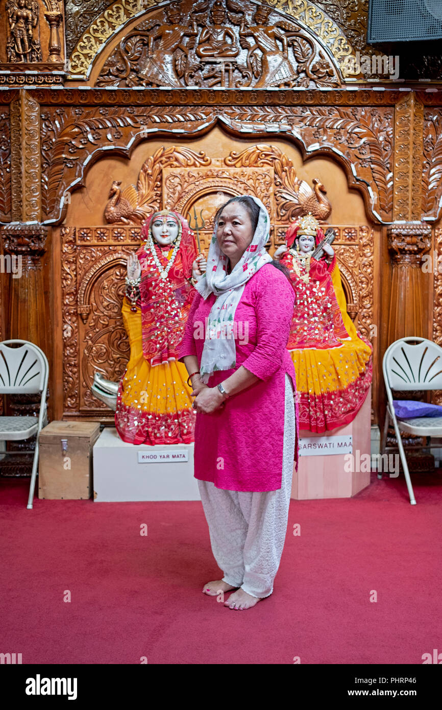 Posed portrait of a Hindu woman from Tibet inside the Geeta Temple in Corona, Queens, New York City Stock Photo