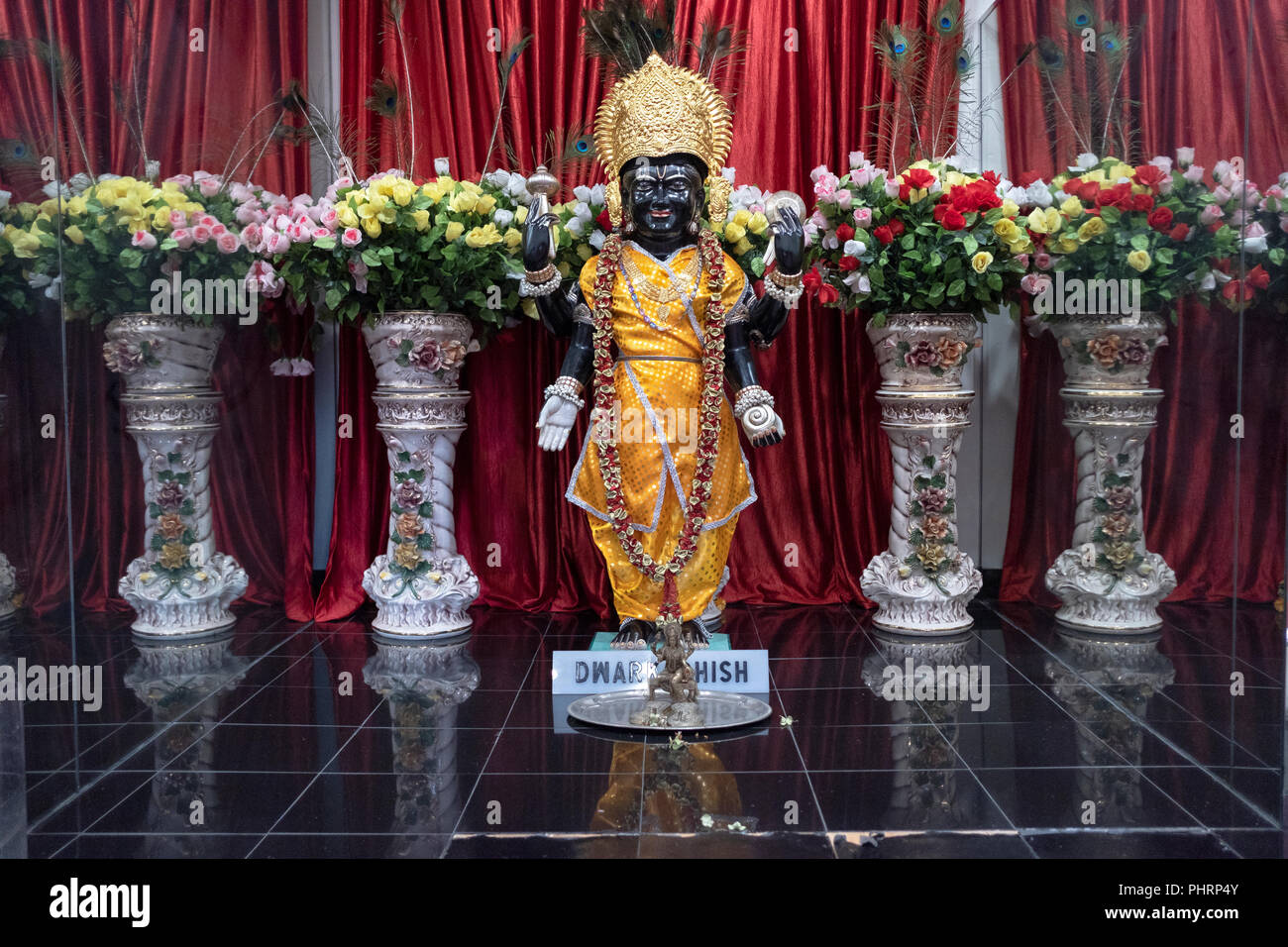 A black statue of the Hindu deity Dwarkhadish at the altar inside the Geeta Temple in Corona, Queens, New York City Stock Photo
