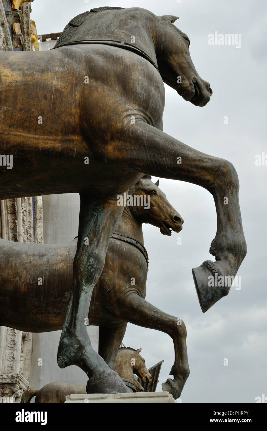 Three of the four bronze horse statues on top of the balcony of the