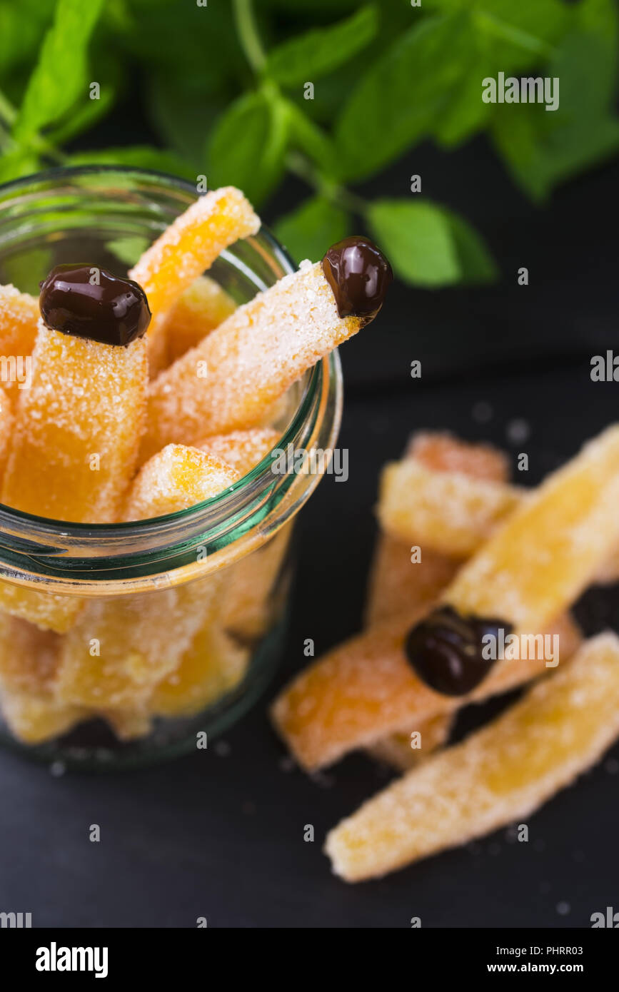 Orange slices in dark chocolate, close-up Stock Photo