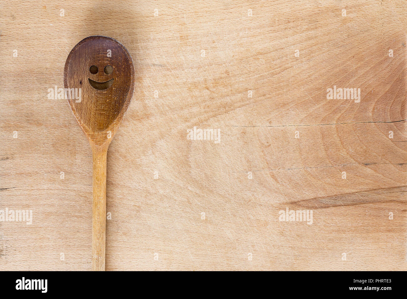 Wooden smiley face spoon on wooden background Stock Photo - Alamy
