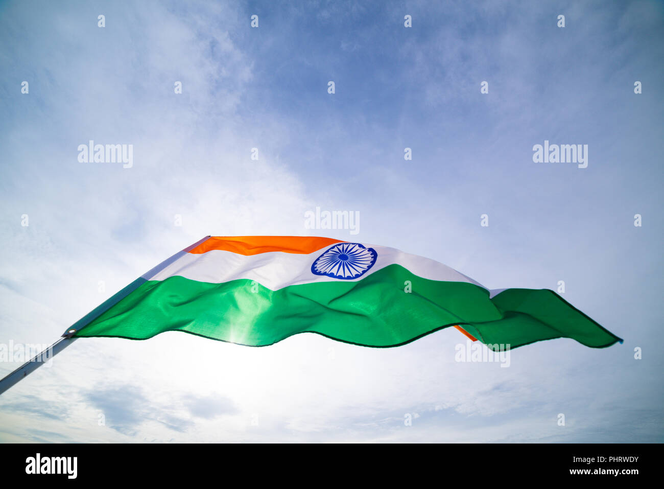 Close up man hand holding India flag on the blue sky background. Indian  Independence Day, 15 August Stock Photo - Alamy