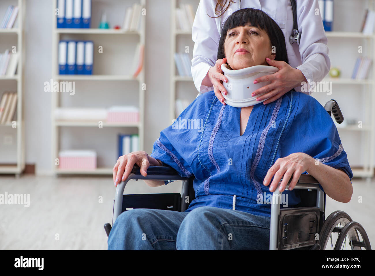 Senior woman with neck injury at doctors Stock Photo Alamy