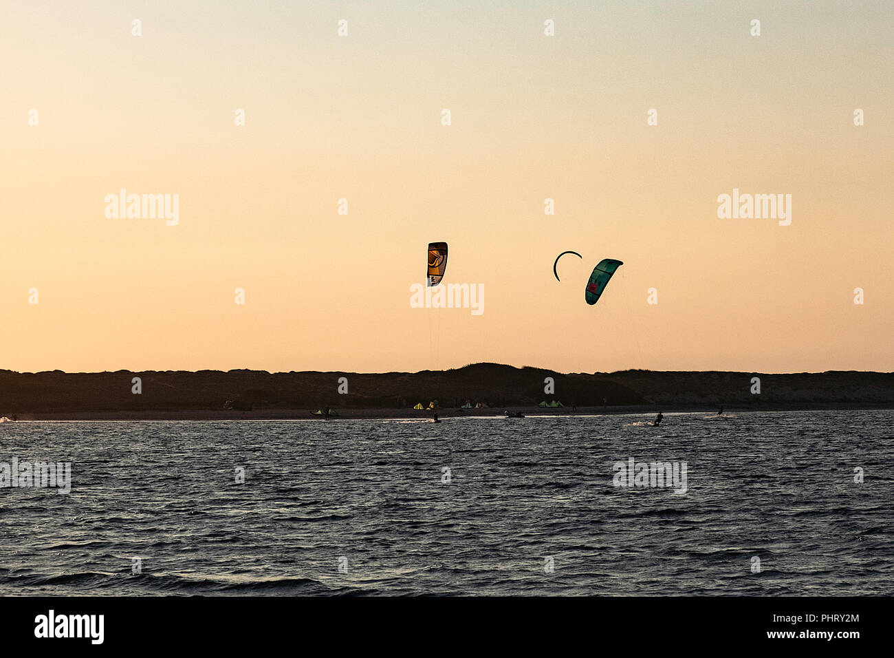 surf kites at sunset hour Stock Photo