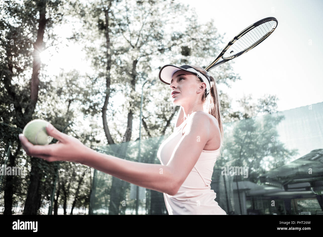 Diligent attractive female player perfecting tennis technique Stock Photo